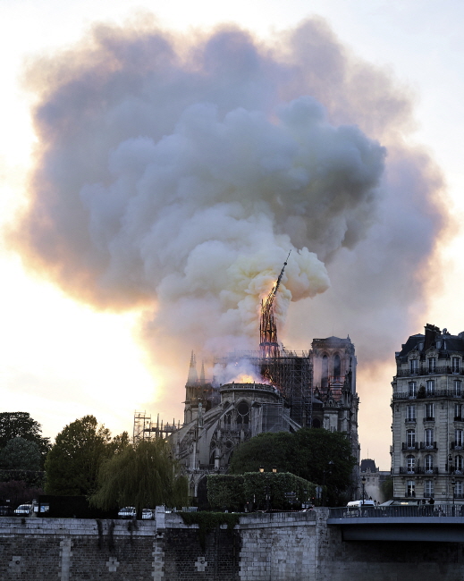 프랑스 파리의 노트르담 대성당 중앙 첨탑이 15일(현지시간) 불길에 휩싸여 옆으로 쓰러지고 있다.